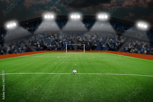 Soccer ball on field in stadium at night © somkanokwan
