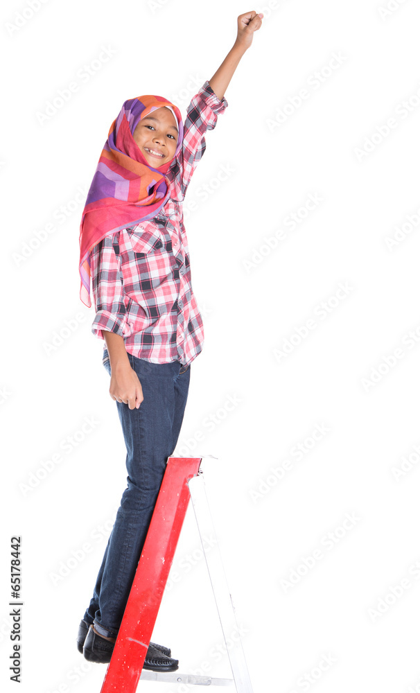 Young Asian Muslim school girl climbing a ladder with backpack Young Asian Muslim school girl climbing a ladder with backpack