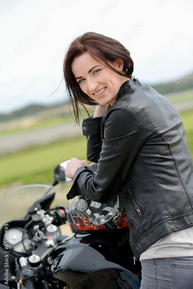cheerful and beautiful young woman riding motorbike cheerful and beautiful young woman riding motorbike