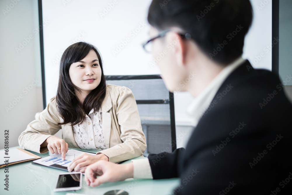 Successful young business executives meeting at the office Successful young business executives meeting at the office