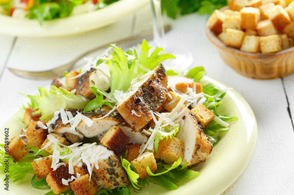 Caesar chicken salad on white table Caesar chicken salad on white table