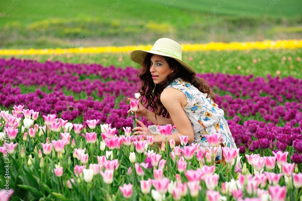 Beautiful hatted girl in tulips farm Beautiful hatted girl in tulips farm