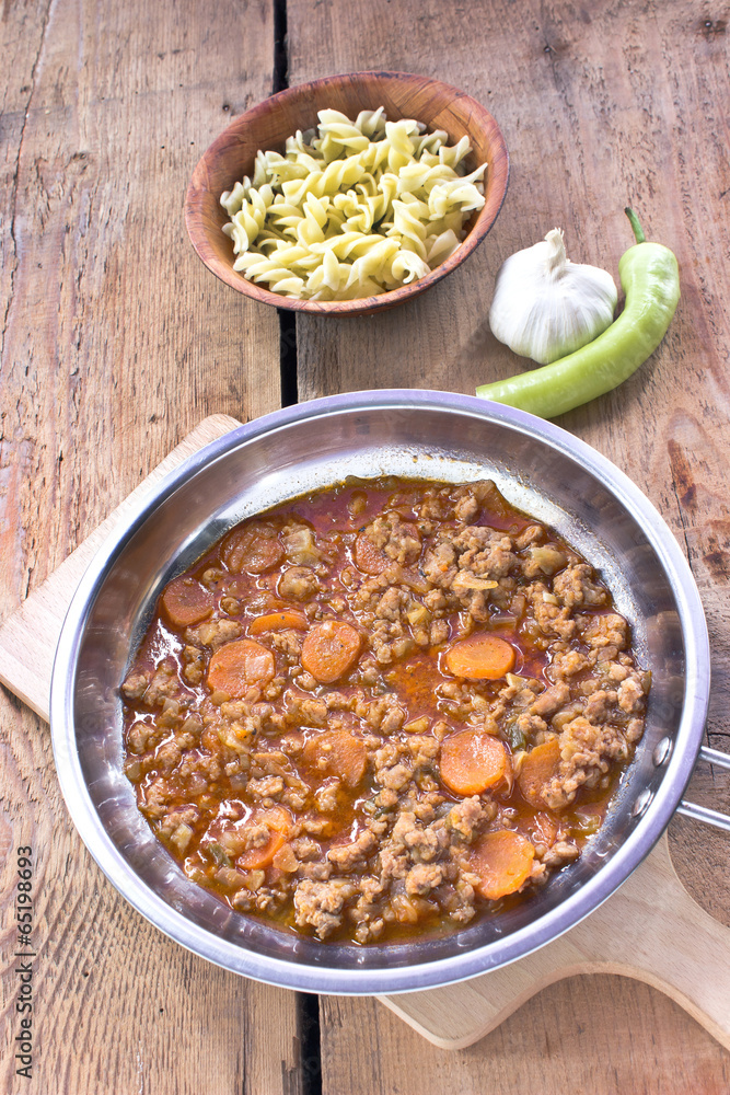 Minced meat sauce with vegetables cooked in pan with pasta Minced meat sauce with vegetables cooked in pan with pasta