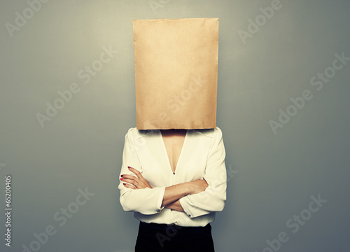 woman hiding under empty paper bag