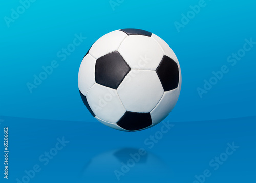 Soccer ball over blue © Eugene Antoschenko
