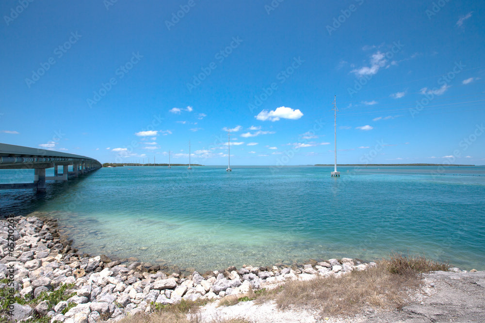 Shoreline of the Florida Keys with pretty blue sky and clouds.