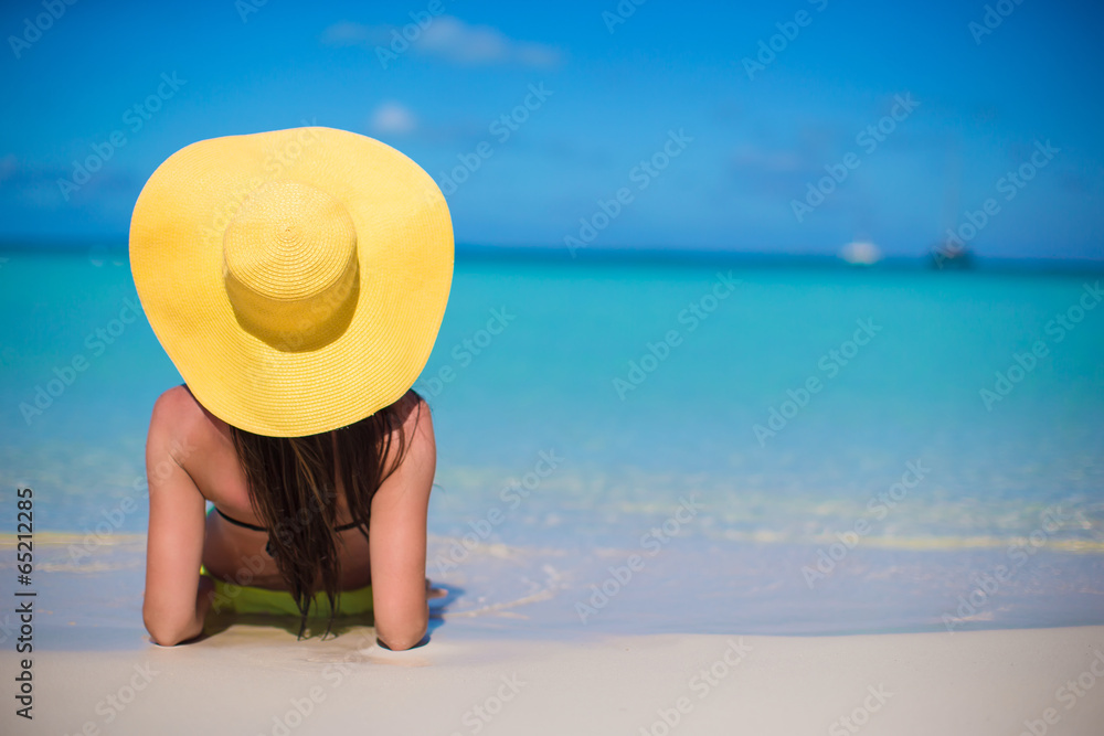 Young woman in hat on the beach enjoy caribbean vacation