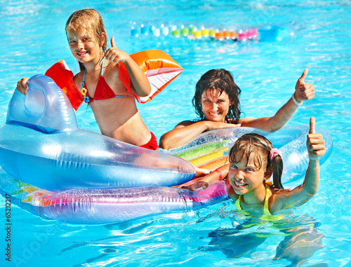 Family in swimming pool.