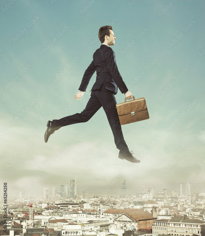 Conceptual photo of flying businessman