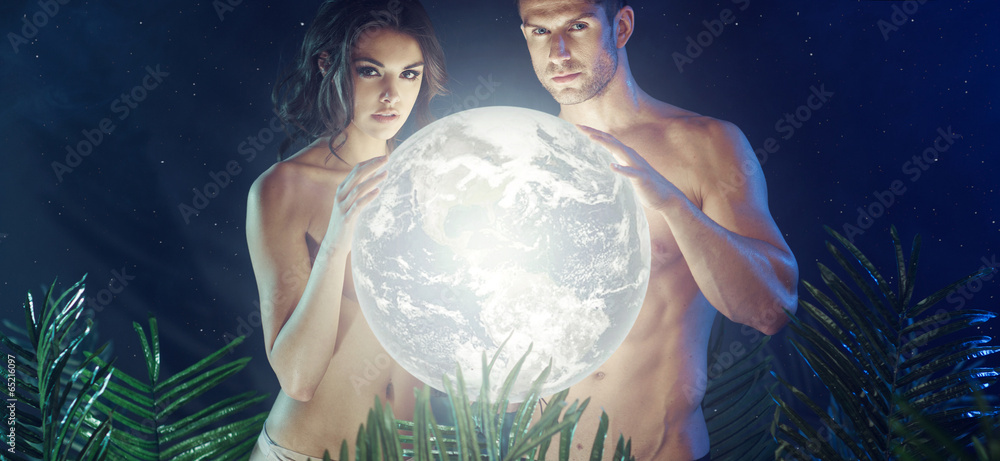 Naklejka premium Attractive young couple holding shiny Earth