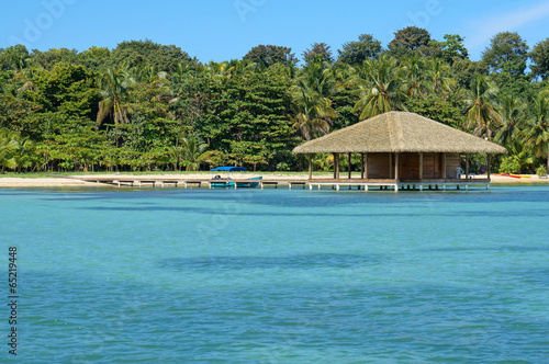 Tropical beach and bungalow over water