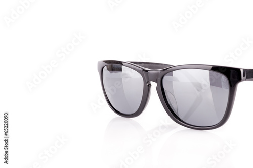 Modern dark sunglasses with a black frame on a white background
