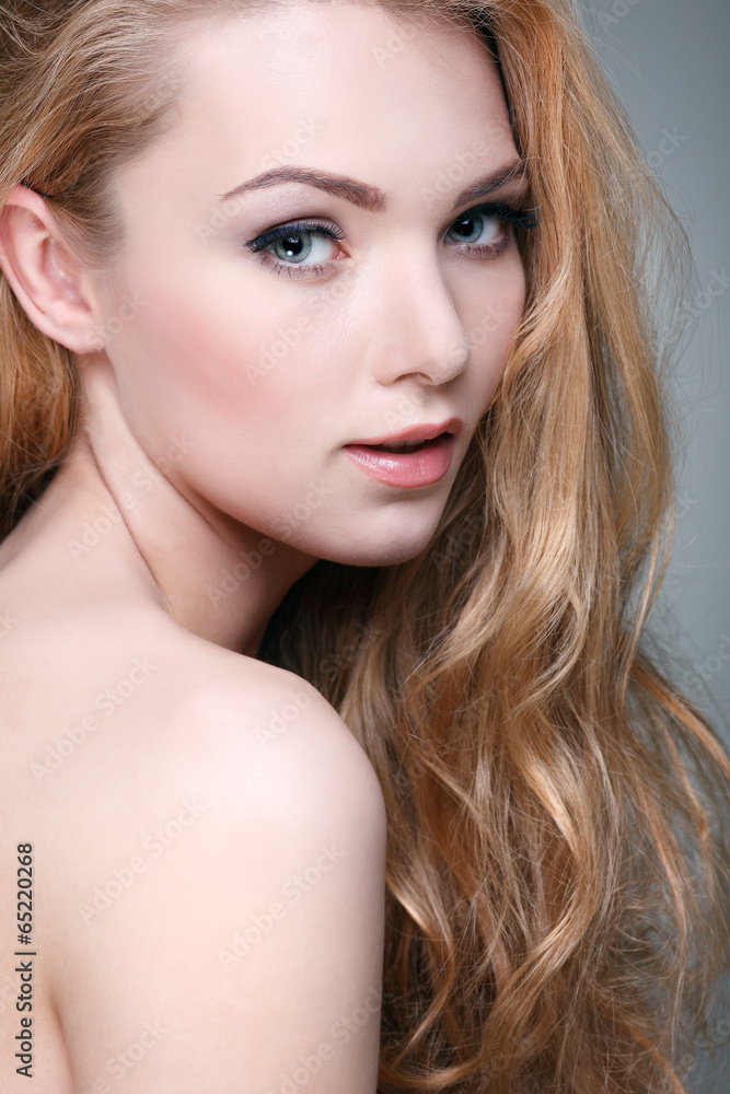 Naklejka premium Beautiful girl, isolated on a light - grey, emotions, cosmetics