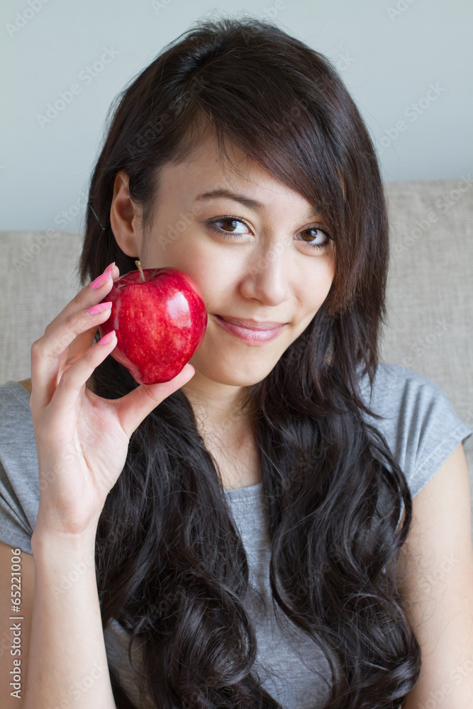 healthy woman with red apple, mixed race asian caucasian indoor healthy woman with red apple, mixed race asian caucasian indoor