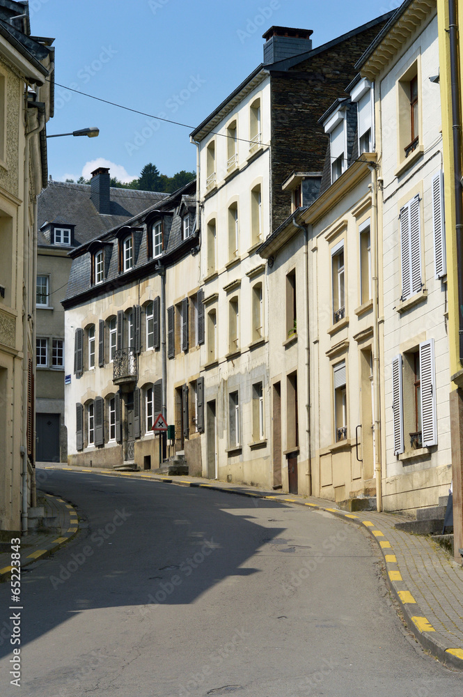 A curved street with houses in Belgian town of Bouillon
