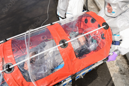 Biohazard team with virus patient in stretcher