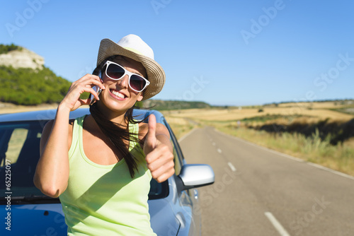 Woman calling on cellphone during summer car travel