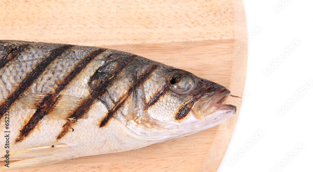 Close up of grilled seabass fish on platter. Close up of grilled seabass fish on platter.