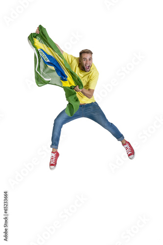 young attractive brazil supporter jumping with Brazil flag