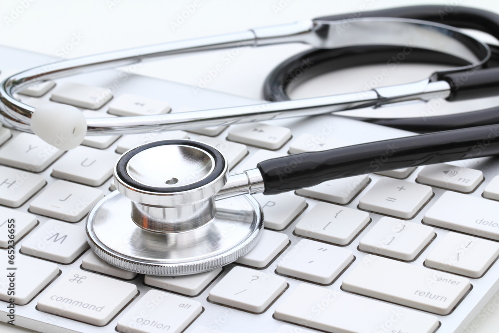 Stethoscope isolated on white with a modern computer keyboard Stethoscope isolated on white with a modern computer keyboard