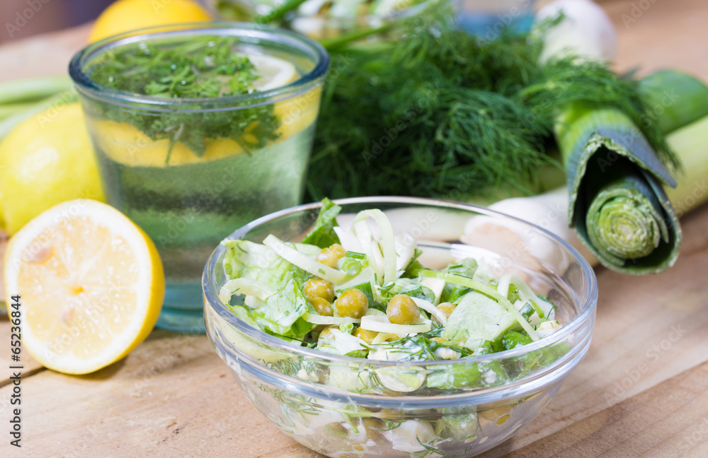 lemonade with parsley and bowl of vegetarian salad lemonade with parsley and bowl of vegetarian salad