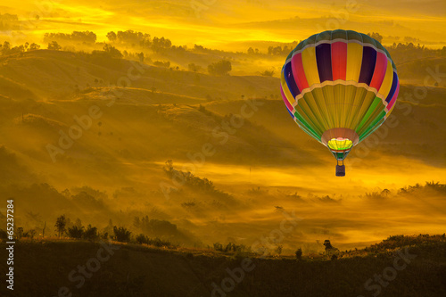 Hot Air Balloon Over Mountainous Autumn Landscape