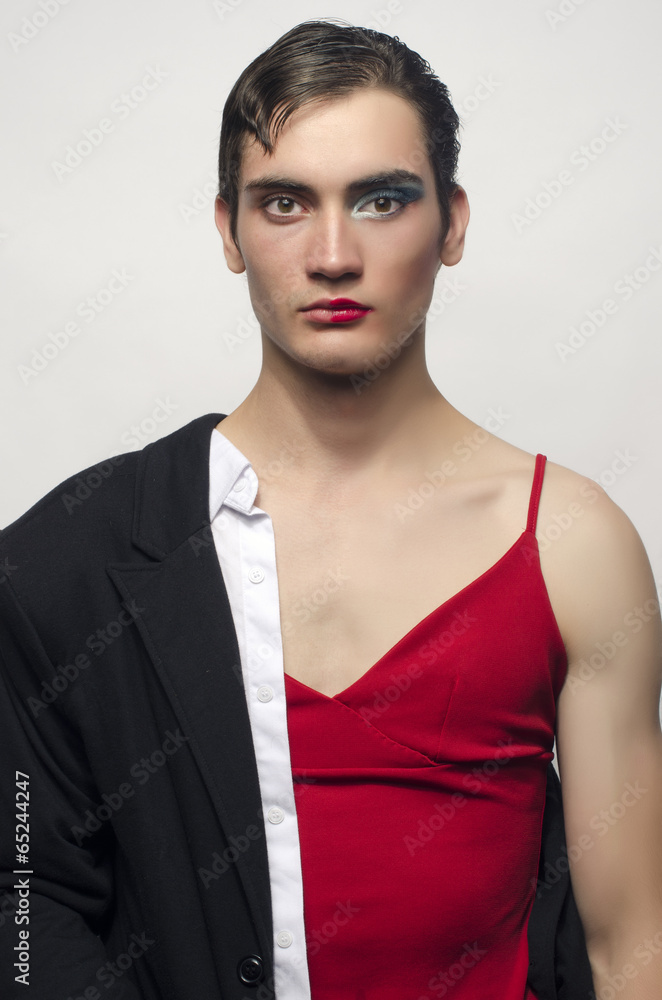 Half man, half woman, wearing a black suit and a red dress. Stock Photo