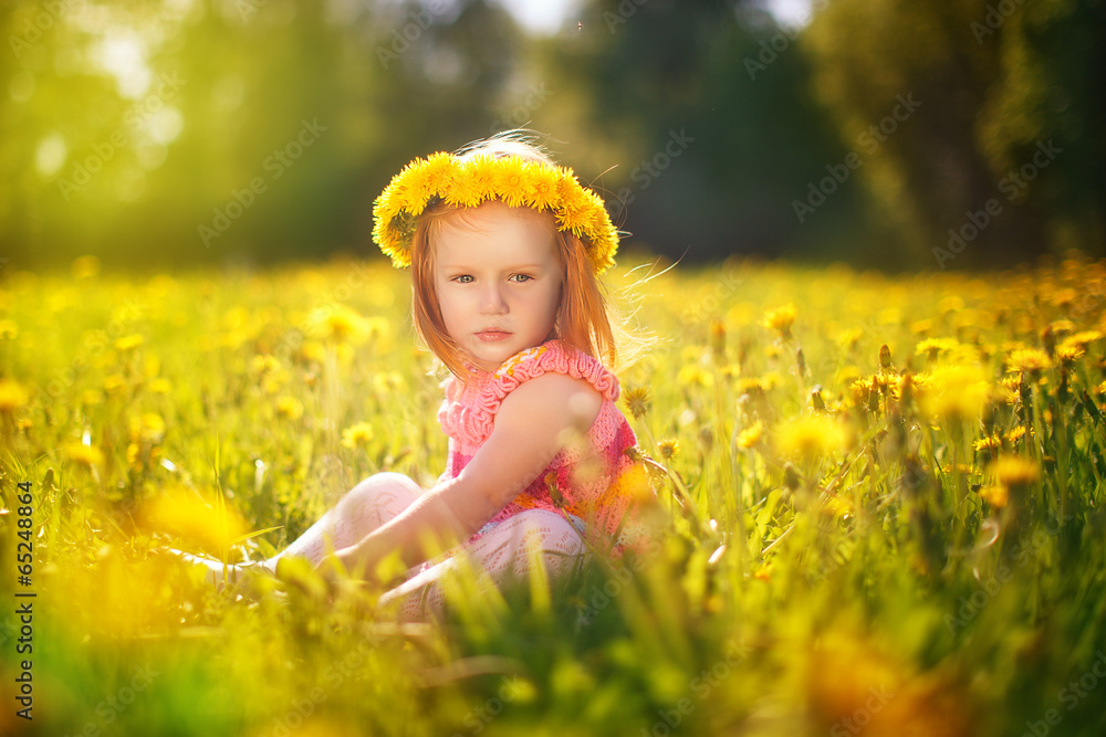 Image of happy child on dandelions field, cheerful little girl r Image of happy child on dandelions field, cheerful little girl r
