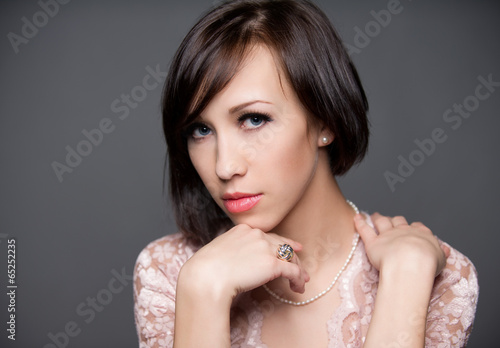 beautiful young woman isolated on grey background
