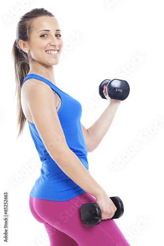 portrait of a young pretty woman holding weights and doing fitne