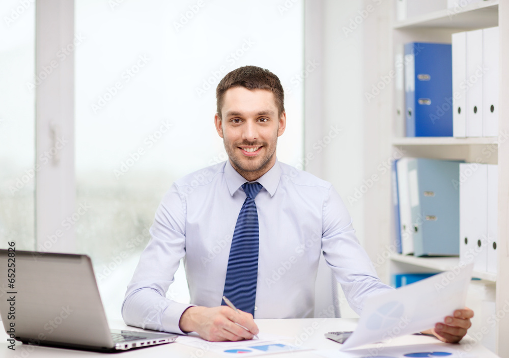 smiling businessman with laptop and documents smiling businessman with laptop and documents