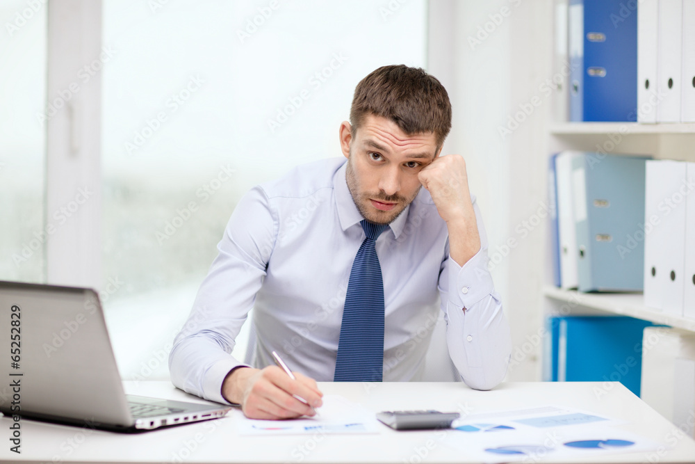stressed businessman with laptop and documents stressed businessman with laptop and documents