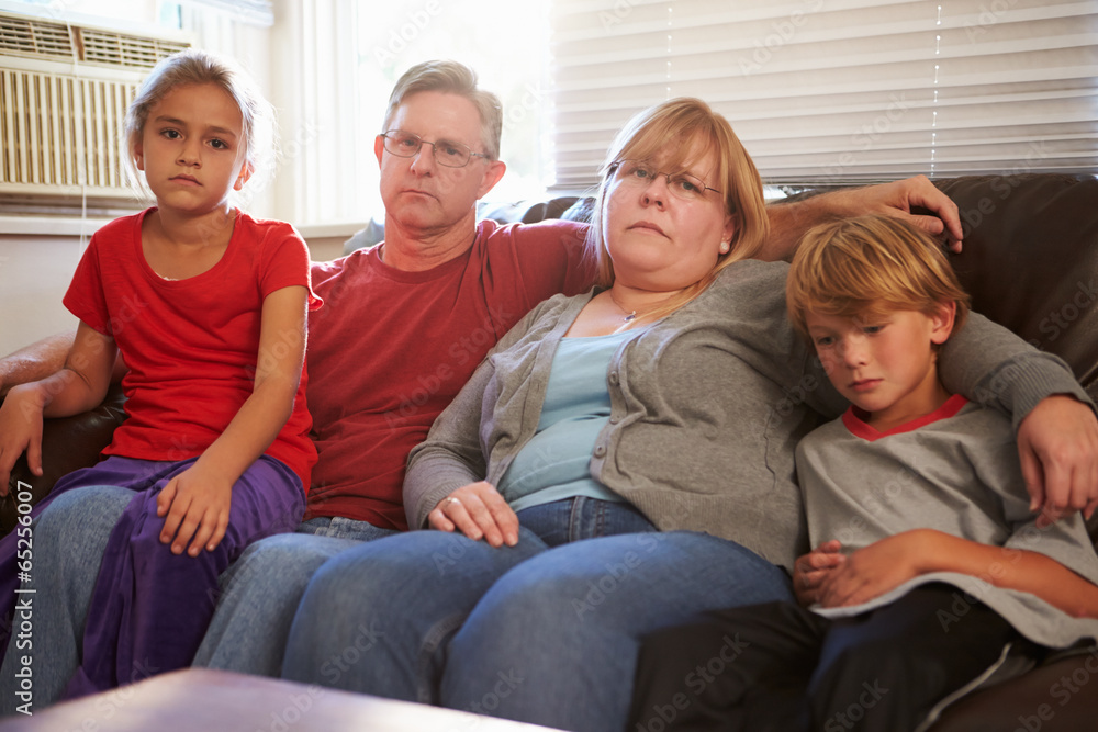 Portrait Of Unhappy Family Sitting On Sofa Together Portrait Of Unhappy Family Sitting On Sofa Together