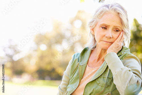Depressed Senior Woman Sitting Outside