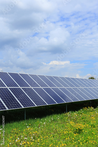 Solar Power Station on the spring flowering Meadow