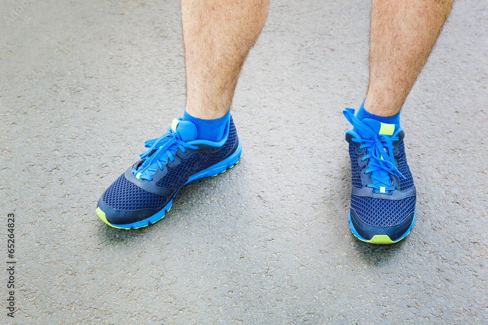 Closeup of a male runner standing - Fitness concept. Closeup of a male runner standing - Fitness concept.