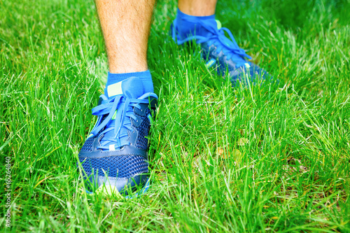 Closeup of a male runner standing - Fitness concept.