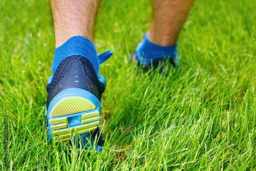 Closeup of a male runner standing - Fitness concept.