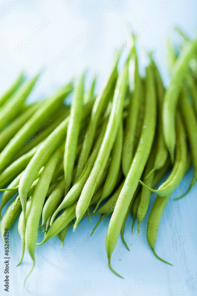 fresh green beans over blue