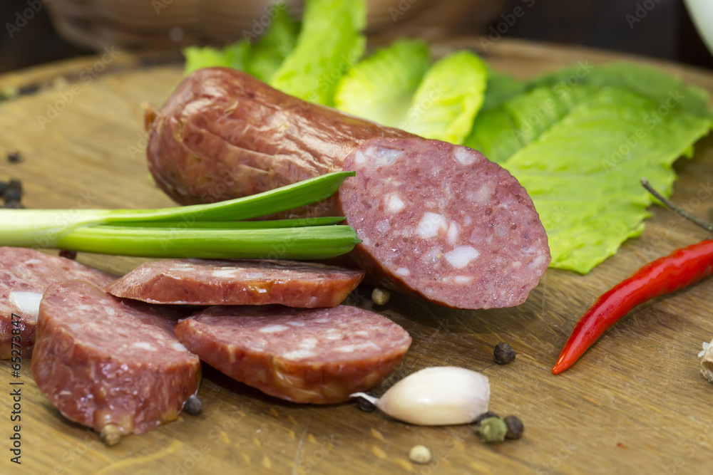 sausage on a wooden plate in a restaurant sausage on a wooden plate in a restaurant