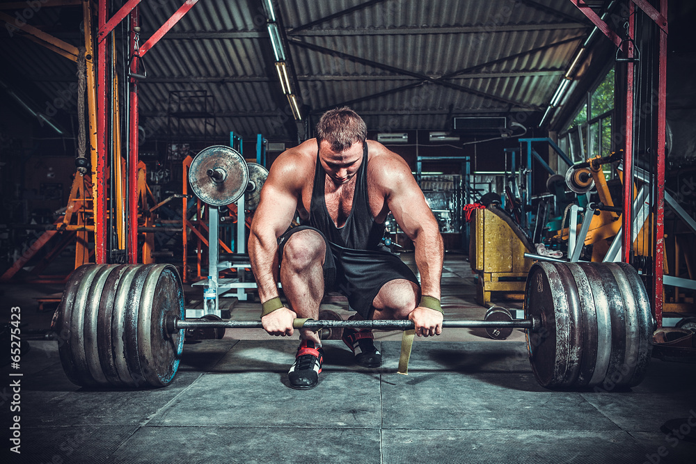 Fotografie, Obraz Powerlifter with strong arms lifting weights | Posters.cz