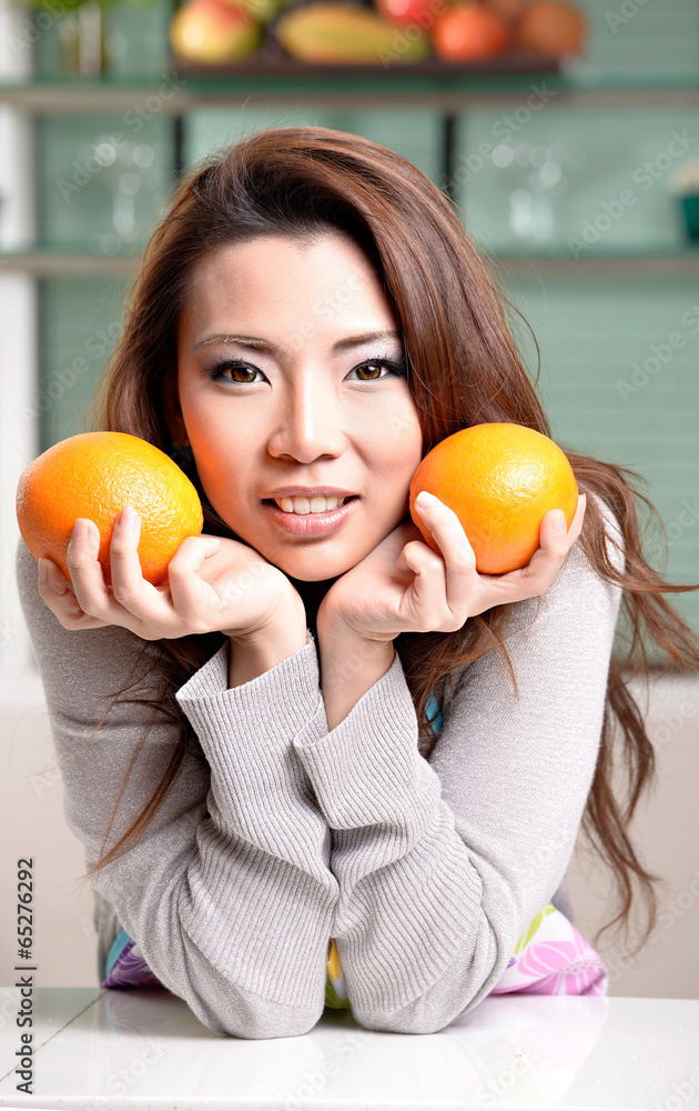 Happy asian woman cooking in the kitchen Happy asian woman cooking in the kitchen