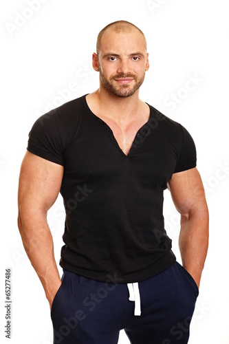 Portrait of muscular man in black shirt on isolated background