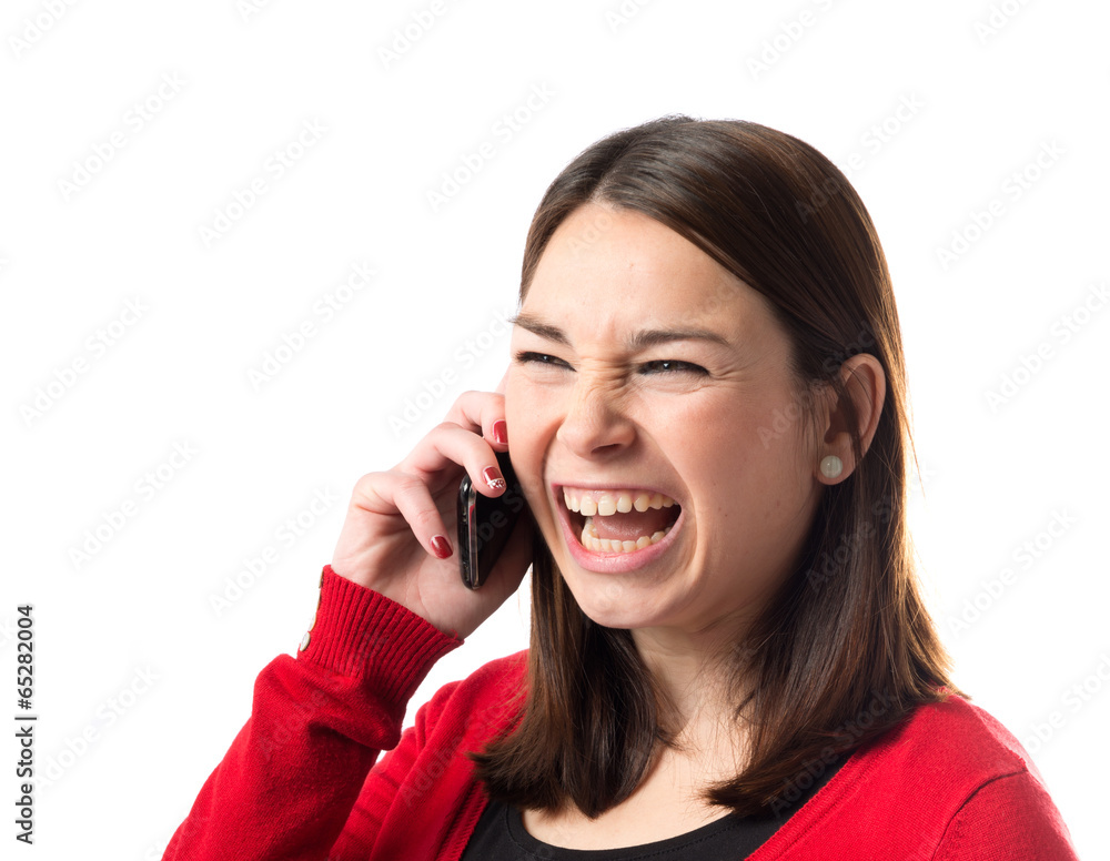 Girl shouting to mobile over isolated background. Girl shouting to mobile over isolated background.