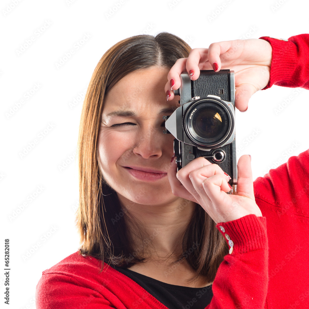 Girl taking a picture over white background Girl taking a picture over white background