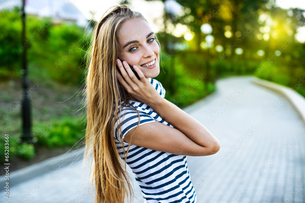 A portrait of a smiling beautiful woman talking on the phone A portrait of a smiling beautiful woman talking on the phone