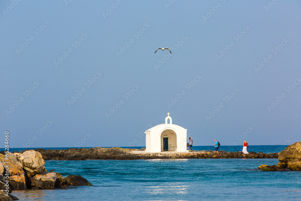 Old venetian lighthouse at harbor in Crete, Greece