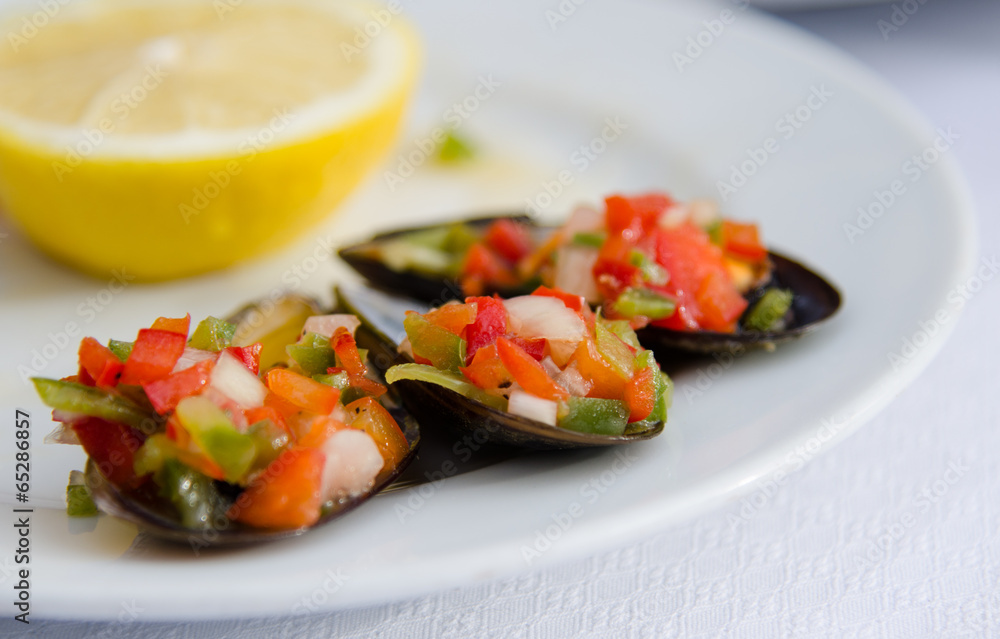 Tapas of chopped peppers, onions, and clams in shells Tapas of chopped peppers, onions, and clams in shells