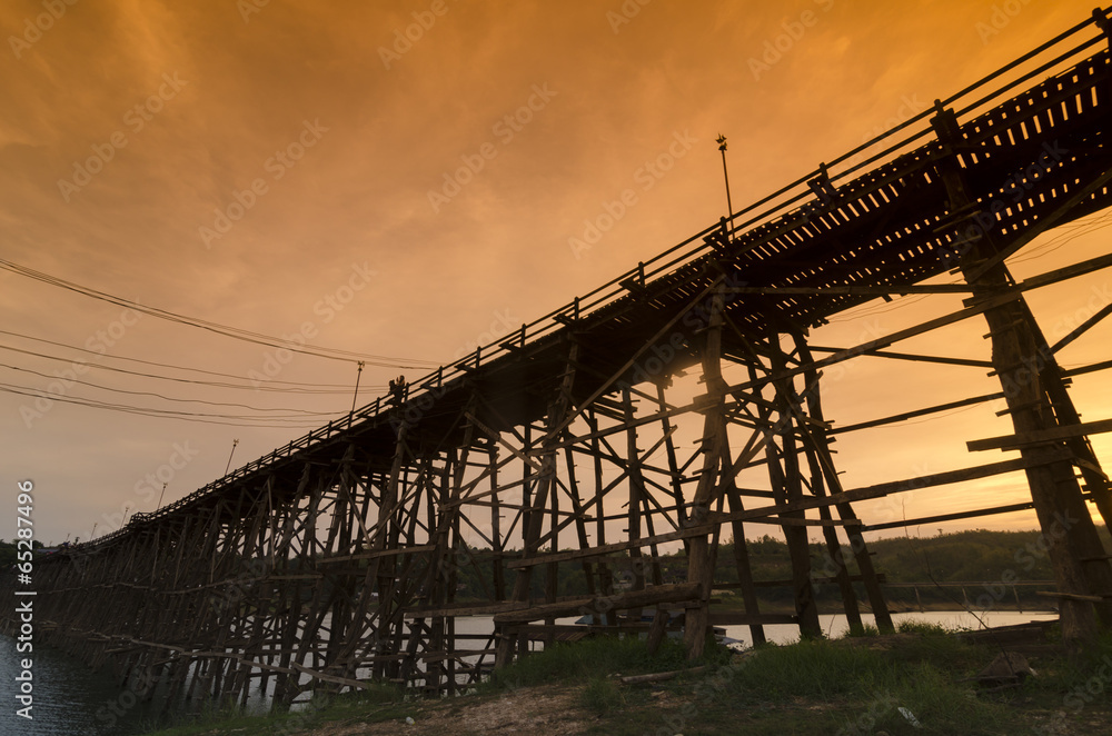 The beautiful wooden bridge with sunrise and fog at Sangklaburi in Kanchanaburi, Thailand