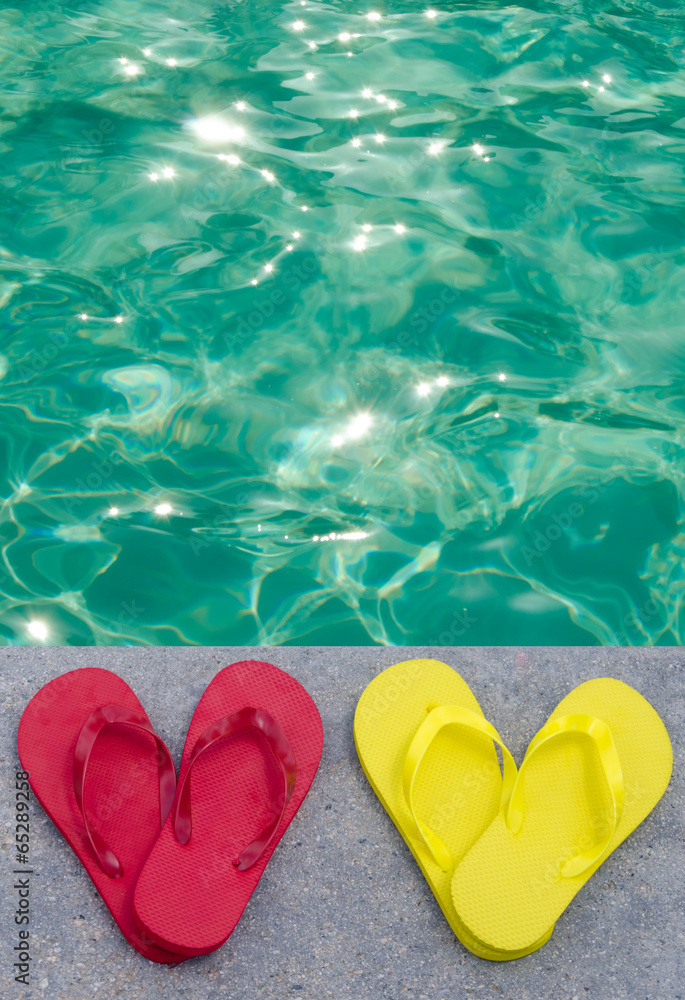 Fototapeta premium Color flip flops by the pool